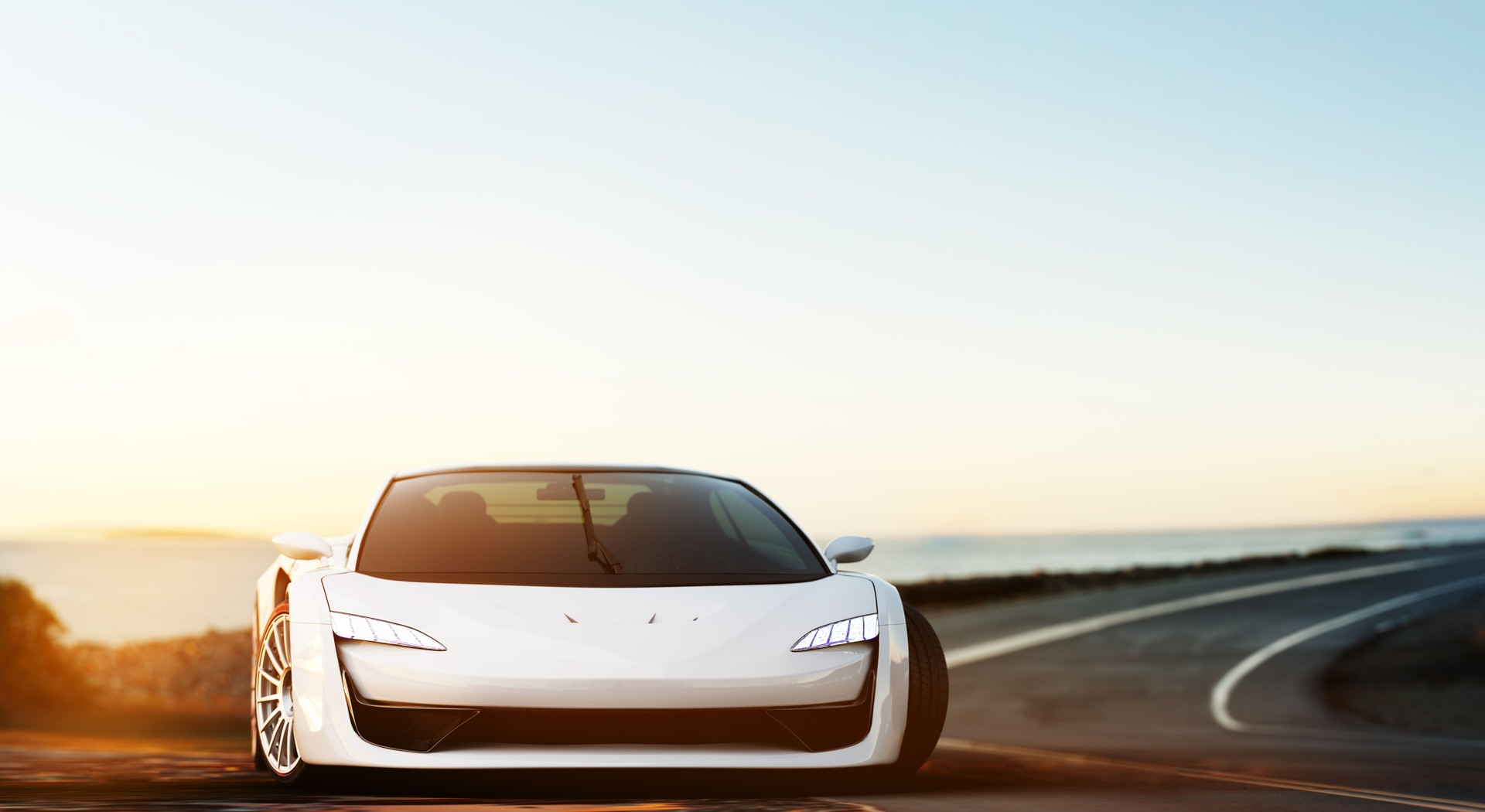 silver sports car standing on a coastal road